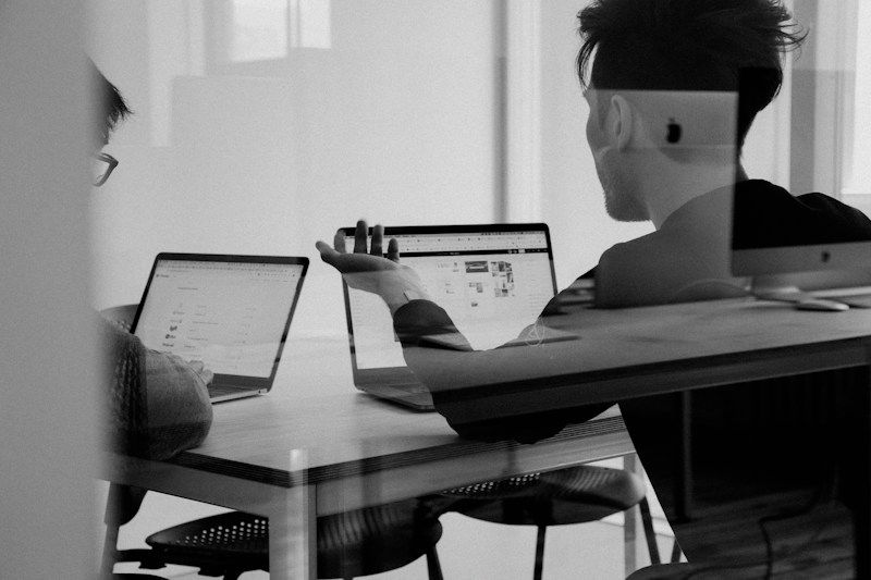 Team analyzing AI search visibility data on laptops